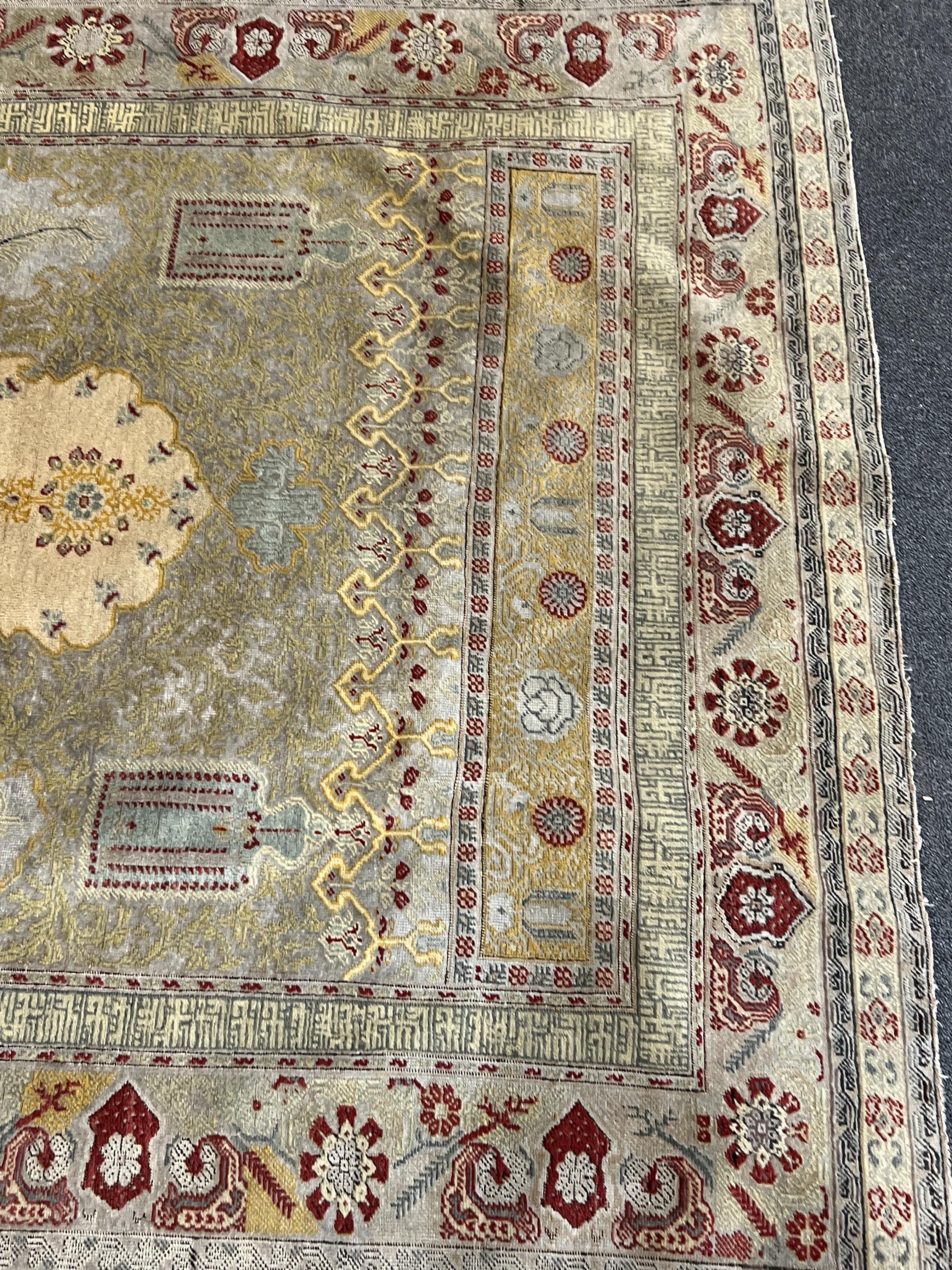 A Turkish silk prayer rug, with central mihrab and stylised floral borders, 205 x 122cm. Condition - worn and faded throughout, all edges worn with a degree of losses.